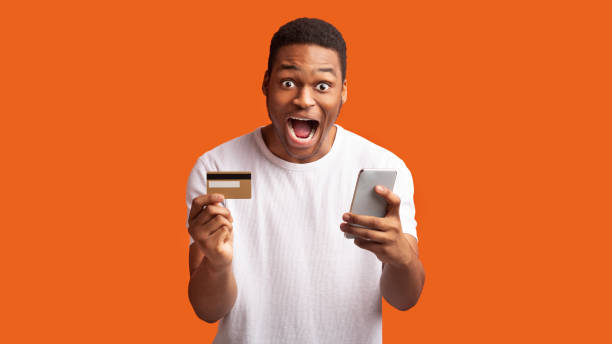 istock African man with smartphone and credit card 1198229985