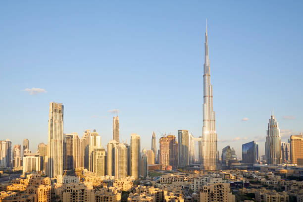 Dubai city skyline with Burj Khalifa skyscraper in a sunny day, blue sky Dubai city skyline with Burj Khalifa skyscraper in a sunny day, blue sky burj khalifa photos stock pictures, royalty-free photos & images