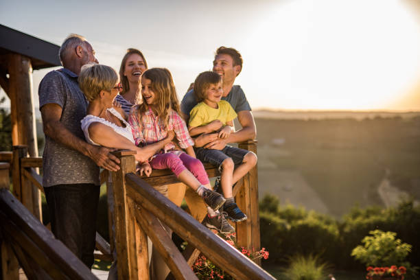istock Happy extended family having fun while talking on a terrace. 1198230797