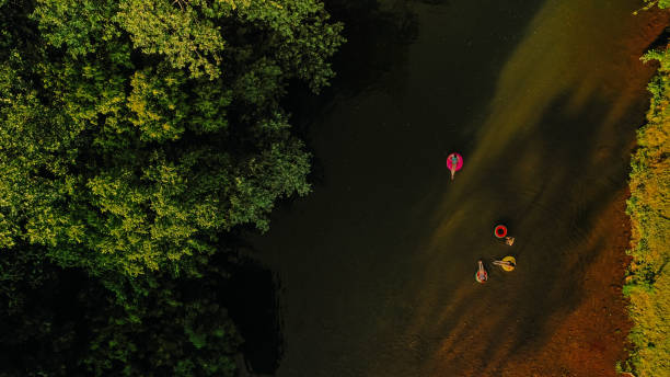 istock Girlfriends on inflatable rings in the river 1198231119