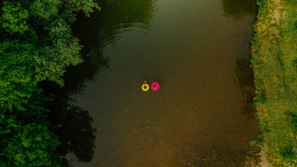 istock Young couple on inflatable rings in the river 1198231121