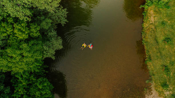 istock Young couple on inflatable rings in the river 1198231192