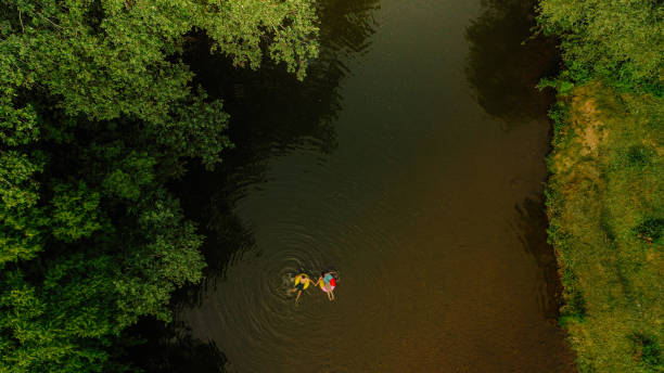 istock Young couple on inflatable rings in the river 1198231193