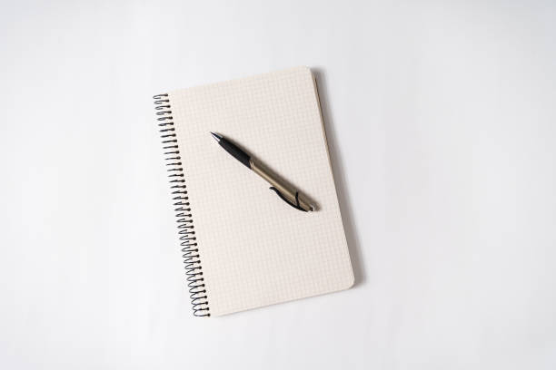 istock Pen on a blank page of an open notebook. White background. Creativity, muse, plans 1198231298