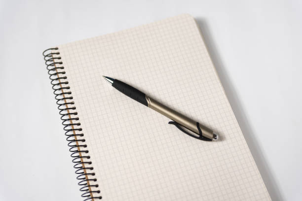 istock Pen on a blank page of an open notebook. White background. Creativity, muse, plans 1198231306