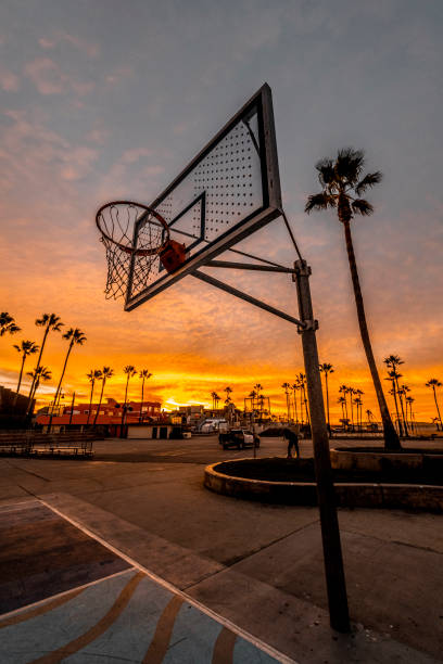 Basketball court at Venice beach, Los Angeles, California, captured during dusk Basketball court at Venice beach, Los Angeles, California, at golden hour. asphalt basketball court stock pictures, royalty-free photos & images