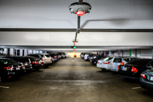 Car parking slot availability indicators placed on a garage ceiling.