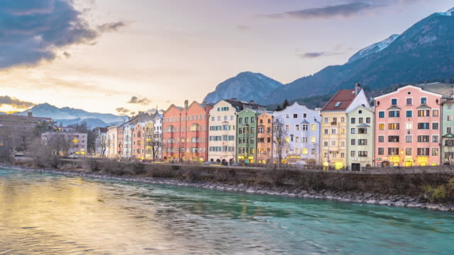 Time lapse of colorful buildings and river of Innsbruck, Austria during a winter sunset