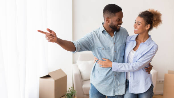 istock Afro Man Showing Girlfriend View From Their New Home, Panorama 1198232375