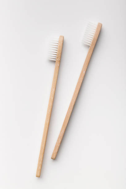 istock Two bamboo toothbrushes isolated on the white background 1198232630