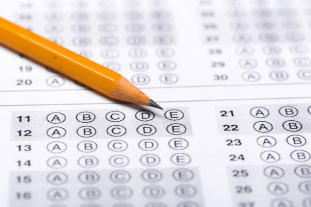 istock testing in exercise and exam paper. computer sheet with pencil in school test room, education concept 1198234971