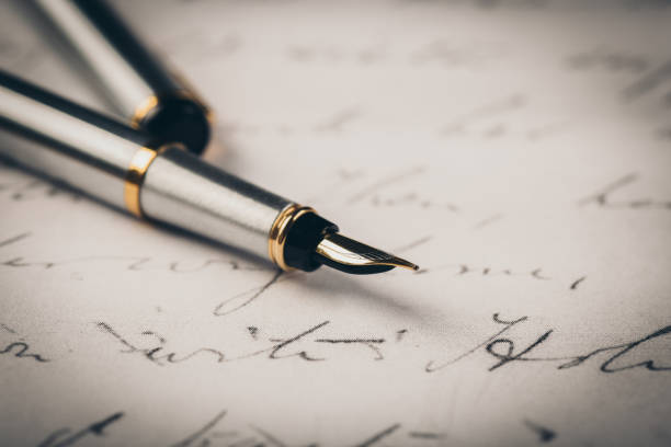 istock Fountain pen on an ancient handwritten letter. Old story. Retro style. 1198234981