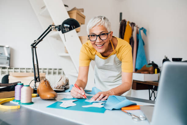 istock Mature shoemaker starting a new production line 1198237502
