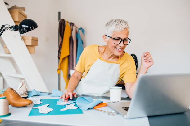 istock Mature shoemaker working on the new shoes design 1198237506