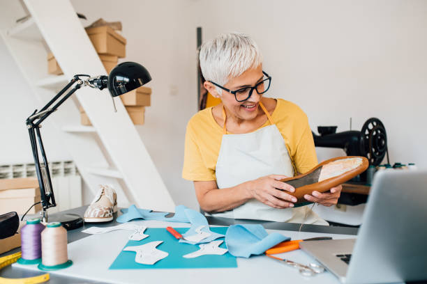 istock Mature shoemaker working on her handmade products 1198237508