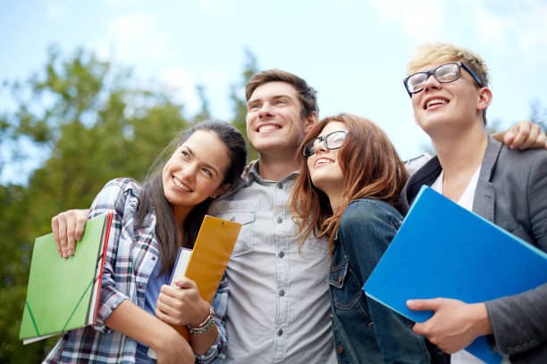 istock group of happy students with folders outdoors 1198237636