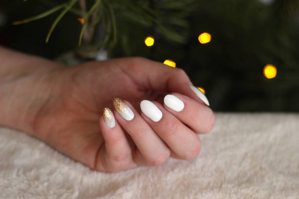 istock white nails with gold and silver glitter on a dark background, bokeh, fur 1198237682