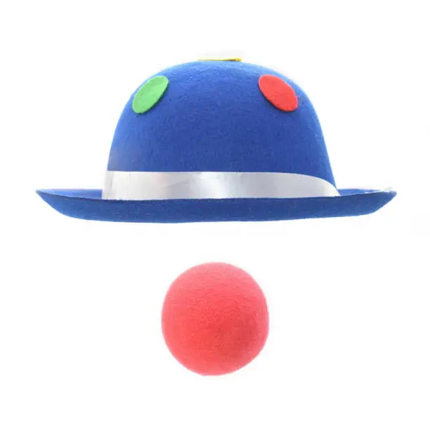 Blue clown hat and red nosse isolated on white