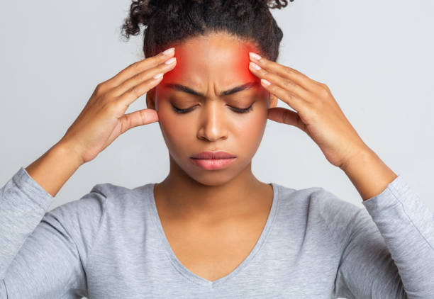 istock African girl touching her temples, suffering from migraine 1198238457