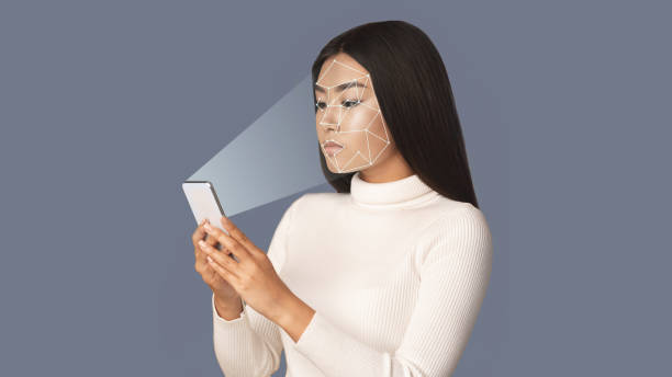 istock Biometric verification. Girl with smartphone using face ID 1198238720