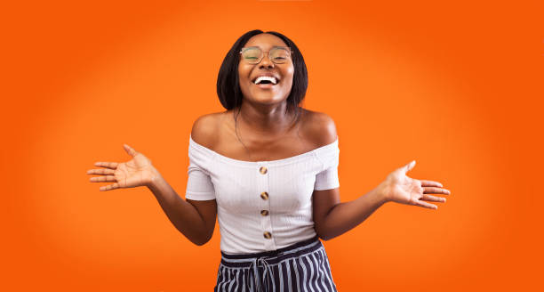 istock Happy Black Woman Laughing Gesturing With Hands, Orange Background, Panorama 1198238877