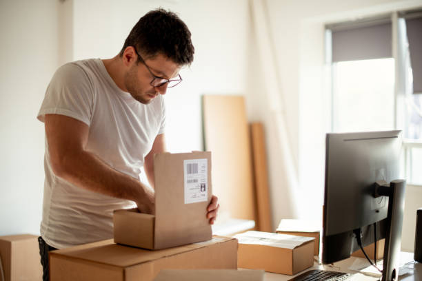istock Delivery service, working in warehouse with packages 1198238881