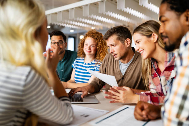 istock Creative brainstorming. Happy business people, designers, architects working as a team in office 1198239985