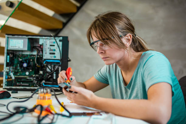 istock Blonde women repairing computer 1198240564