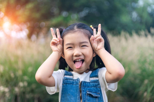 istock Little girl Playing games Imitation bunny 1198241606