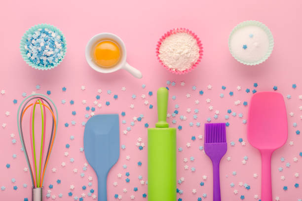 istock baking ingredients, egg, flour, sugar, sweet decoration and kitchen tools on pink background 1198241632