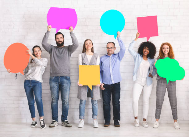 istock Group of diverse friends holding blank colorful speech bubbles 1198241835