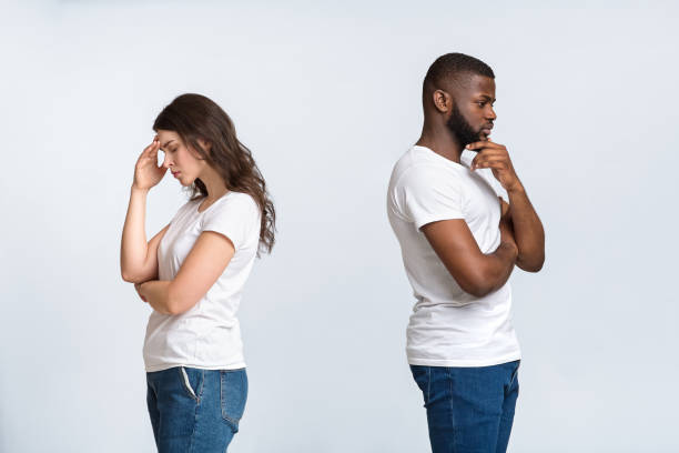 istock Pensive man and woman standing back to back after quarrel 1198242887