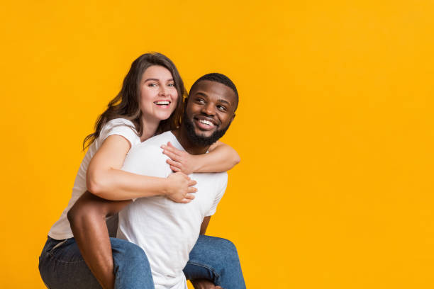 istock Cheerful black guy piggibacking his girlfriend, interracial couple having fun together 1198242954
