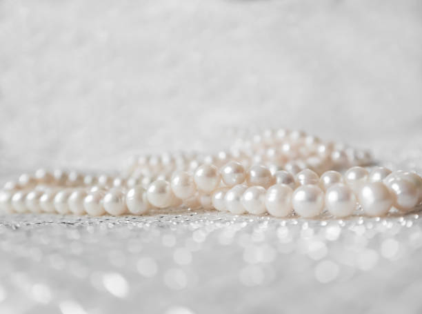 istock Nature white string of pearls on a sparkling background in soft focus, with highlights 1198243469