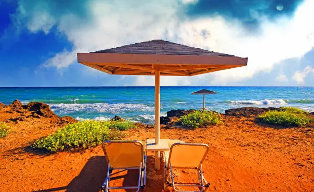 Photo of Umbrellas and sundecks of the sandy Banana Beach on Zakynthos, Greece. Banana is the largest beach of Zakynthos island.