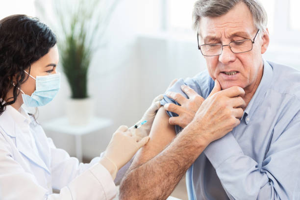 istock Brazilian nurse doing vaccination to senior man 1198244376