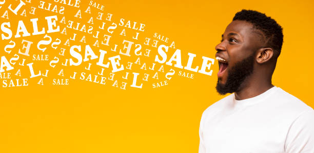 istock Excited black guy screaming sale at copy space on yellow background 1198244577