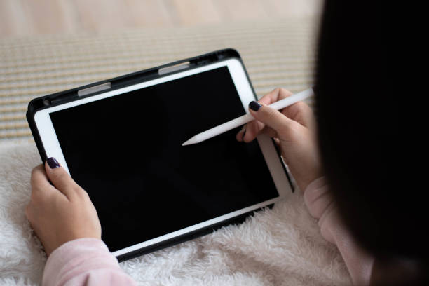 istock Modern woman working at home using tablet or tablet computer with pen 1198245526