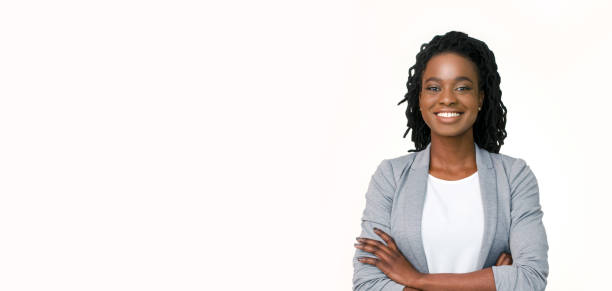 Confident afro businesswoman posing with folded arms on white background Millennial Businesswoman. Confident black woman in suit posing with folded arms on white background, horizontal banner, wide long shot, panorama secretary photos stock pictures, royalty-free photos & images