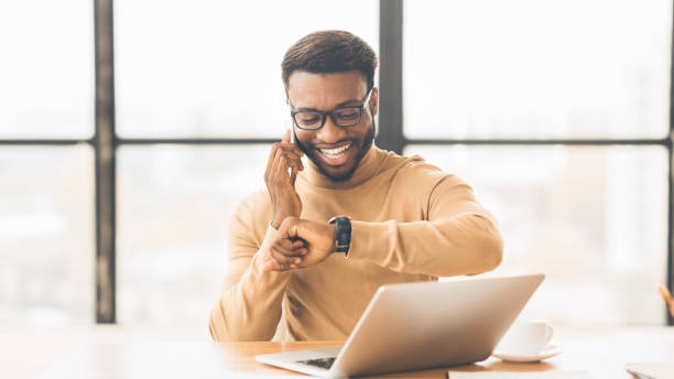 istock African businessman checking time talking on phone 1198245779