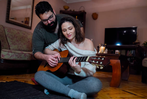 istock Romantic couple with acoustic guitar 1198247456