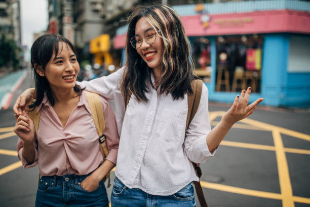istock Two young women students hugging on the street 1198248653