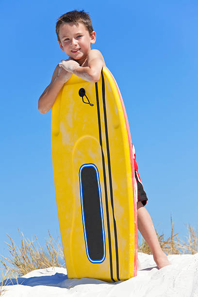 istock Young Boy Child With Surfboard At The Beach 119824880
