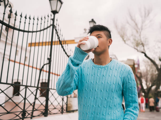 istock Asian man drinking a cup of coffee. 1198249072