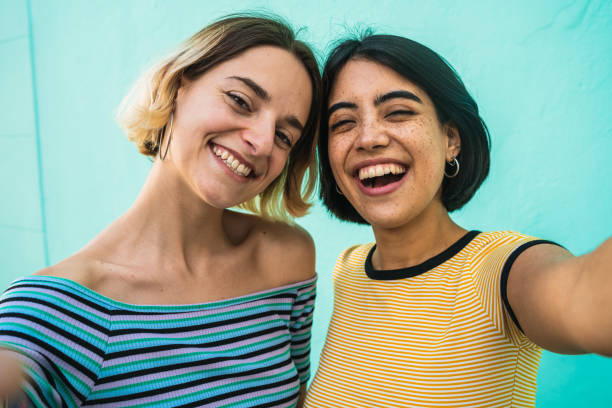 istock Lovely lesbian couple taking a selfie. 1198249078