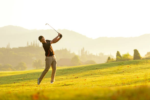 istock Professional Golfer asian man swing and hitting golf ball practice at golf driving range and fairway in sunny morning day on club golf. Lifestyle and Sport Concept 1198250058