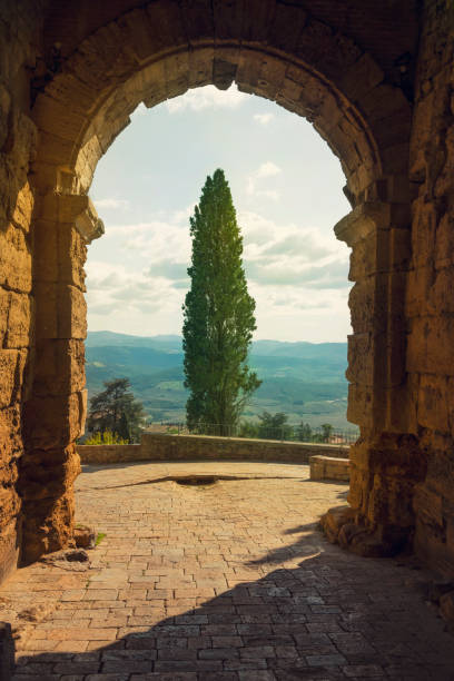Scenic Tuscany landscape framed with a stone archway