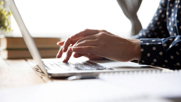Female professional student using laptop at desk, close up view Female hands of business woman professional student using laptop sit at home office desk typing on computer keyboard study work with pc software tech concept, online job and education, close up view creative writing class stock pictures, royalty-free photos & images