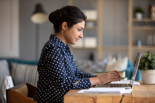 istock Indian girl using laptop study in internet sit at table 1198252562