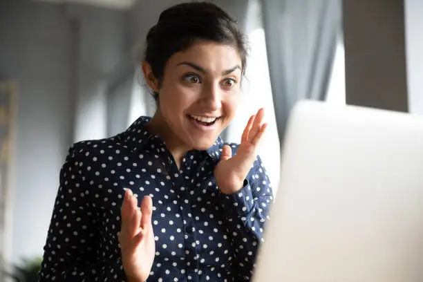 Photo of Amazed young indian girl student wow reaction look at laptop